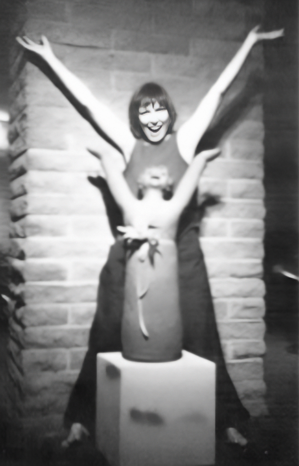 A black and white photo of sculptor Margaret Hudson with her work, "Joy."