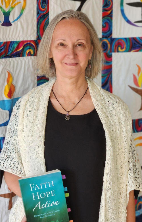 A picture of Diana Ensign holding her book, Faith, Hope, Action.