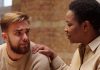 A photo of a woman consoling a man who appears upset.