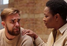 A photo of a woman consoling a man who appears upset.